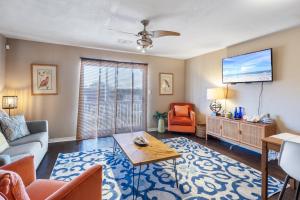 a living room with a couch and a tv at Kate's Place - 13554 Perdido Key Drive in Pensacola