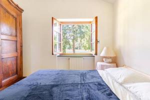 a bedroom with a large bed and a window at Golf House - Valle Christi in Rapallo