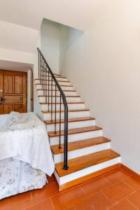 a staircase in a bedroom with a bed next to it at Golf House - Valle Christi in Rapallo