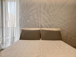 a bed with two pillows in a bedroom at mentamarina in Porto Recanati