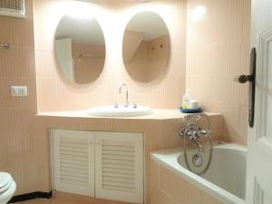 y baño con 2 espejos, lavamanos y bañera. en La Casa del Faro, en Porto Ercole 51 fotos más