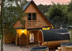 a log cabin with a deck and a balcony at GRABNIK55 in Krasnobród
