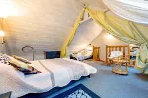 a bedroom with a bed and a tent at Les Hortensias in Hillion