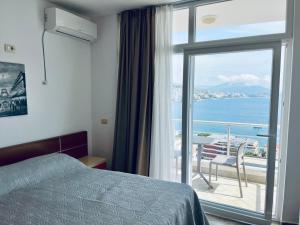 a bedroom with a bed and a view of the ocean at Seaside Serenity! FREE PARKING! in Sarandë