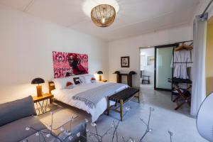 a bedroom with a large bed and a couch at Ohorongo Safari Lodge in Kamanjab +34 photos
