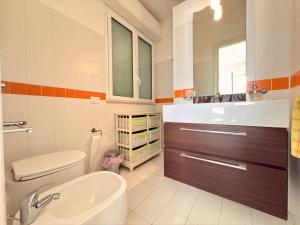 a bathroom with a sink and a toilet and a tub at iDream on the sea in Punta Braccetto +24 photos
