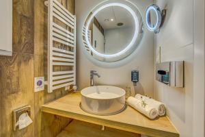 a bathroom with a round sink and a mirror at Novotel Gdańsk Marina in Gdańsk