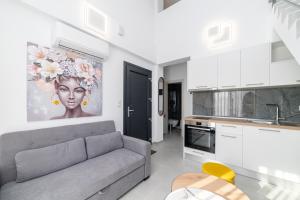 a living room with a couch and a kitchen at Erato Residential Complex in Ofrínion