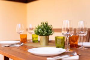 a wooden table with wine glasses and a potted plant at Villa Luxury with pool Tenerife in Las Galletas +33 photos