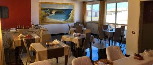 a restaurant with tables and chairs in a room at Bed & Breakfast Isola Bella Lampedusa in Lampedusa