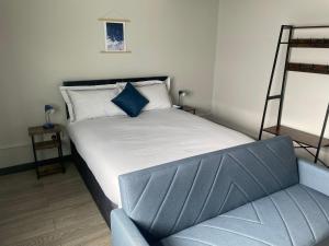 a bedroom with a bed and a ladder and a chair at 1 Bed Flat with King or Twin Beds, Sofa Bed, Work space, Dining and SMART TV with Free Wifi Throughout! in Wingate