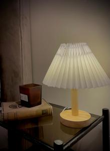 a lamp on top of a table with a box at Cozy nest bedroom - family only in Tangier