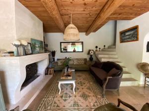 a living room with a couch and a fireplace at Mas Paradou, au coeur des Alpilles in Paradou