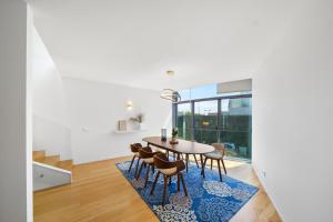 a dining room with a table and chairs on a rug at Pedrinhas Village in Apúlia +24 photos
