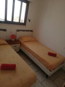a bedroom with two beds and a window at Stellasalentina in Torre Colimena