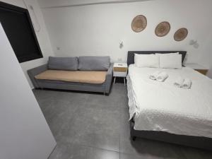 a bedroom with a bed and a couch at Benemanuel Oasis in Beer Sheva