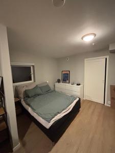 a bedroom with a large bed and a television at 2-roms med parkering i Bodø in Bodø