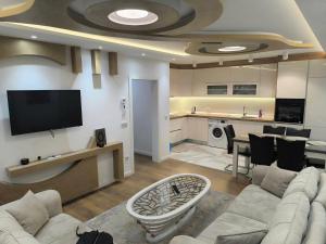 a living room with a couch and a tv at Luxury apartments Sarajevo-free parking in Sarajevo