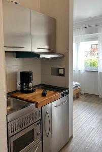 a kitchen with a sink and a stove top oven at Boardinghouse Gruber in Kranzberg