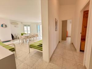 a room with a table and chairs and a dining room at iDream on the sea in Punta Braccetto