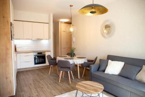 a living room with a couch and a table at Dunasor Apartman in Mohács