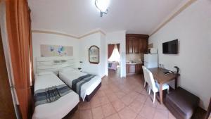 a hotel room with two beds and a table at EURO HOUSE INN airport in Fiumicino