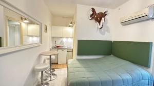 Una pequeña habitación con una cama y una cocina. en Tiny Elephant Mini suite in Rome, en Roma