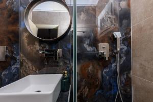 a bathroom with a sink and a mirror and a shower at Dimitreli Eleni Studios in Koinyra