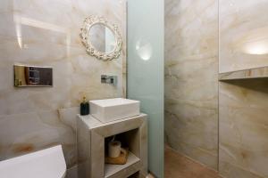 a bathroom with a sink and a mirror at Dimitreli Eleni Studios in Koinyra +13 photos