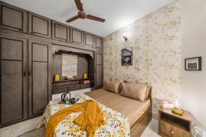 a bedroom with a bed and a ceiling fan at Gaia Homes in Bengaluru