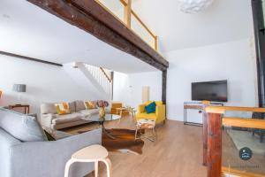 a living room with a couch and a tv at Stable Cottage at Poxwell Manor in Poxwell