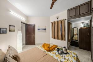a room with a bed with a blanket on it at Gaia Homes in Bangalore