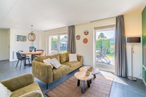 a living room with a couch and a table at Hoogelandt 90A in De Koog