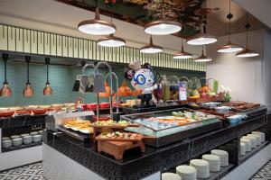 a buffet line with many different types of food at Hampton by Hilton Shanghai North Bund Siping Road in Shanghai
