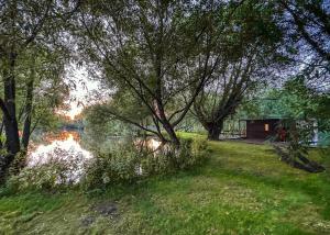 a view of a river with trees and a building at Fairwood Lakes Holiday Park in Westbury