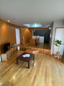 a large living room with a table and a couch at KUMANO家-CoCo- in Shingū
