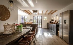 a kitchen with a wooden table and chairs at Vakantiehuis Zand7 in Lommel
