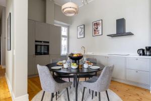 a kitchen with a black table and chairs at Centrally Located 3 Bedroom Apartment in Copenhagen
