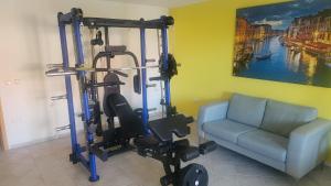 a living room with a gym with a couch at Villa Sunset in Mandre +5 photos