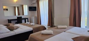 Postel nebo postele na pokoji v ubytování Hotel Cosmos