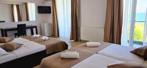 Postel nebo postele na pokoji v ubytování Hotel Cosmos