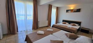 Postel nebo postele na pokoji v ubytování Hotel Cosmos