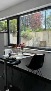 a dining room table with two chairs in front of a window at Wohnung Nähe TU Dortmund in Dortmund