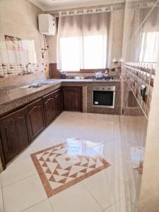 a kitchen with a sink and a stove at Family apartment close to the Beach in jadida in El Jadida