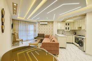 a large living room with a couch and a kitchen at Beachfront Bliss Awaits You at Porto Said in Port Said