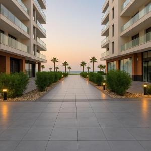 a walkway in a building with palm trees at Beachfront Bliss Awaits You at Porto Said in Port Said