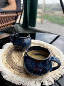 two cups of coffee sitting on a table at Glamping Sfera Marzeń in Szewna +28 photos