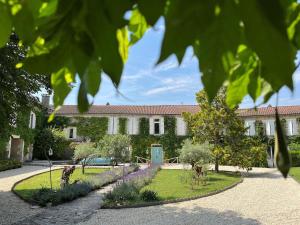 a house with a garden in front of it at Domaine de charme sur lac privé in Dirac