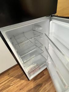 an empty refrigerator with its door open at 4ML Boutique Room in Debrecen