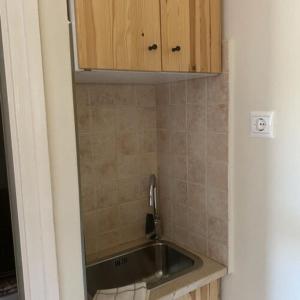 a kitchen with a sink and a cabinet at PIROSCHKA Vendégház Zamárdi in Zamárdi
